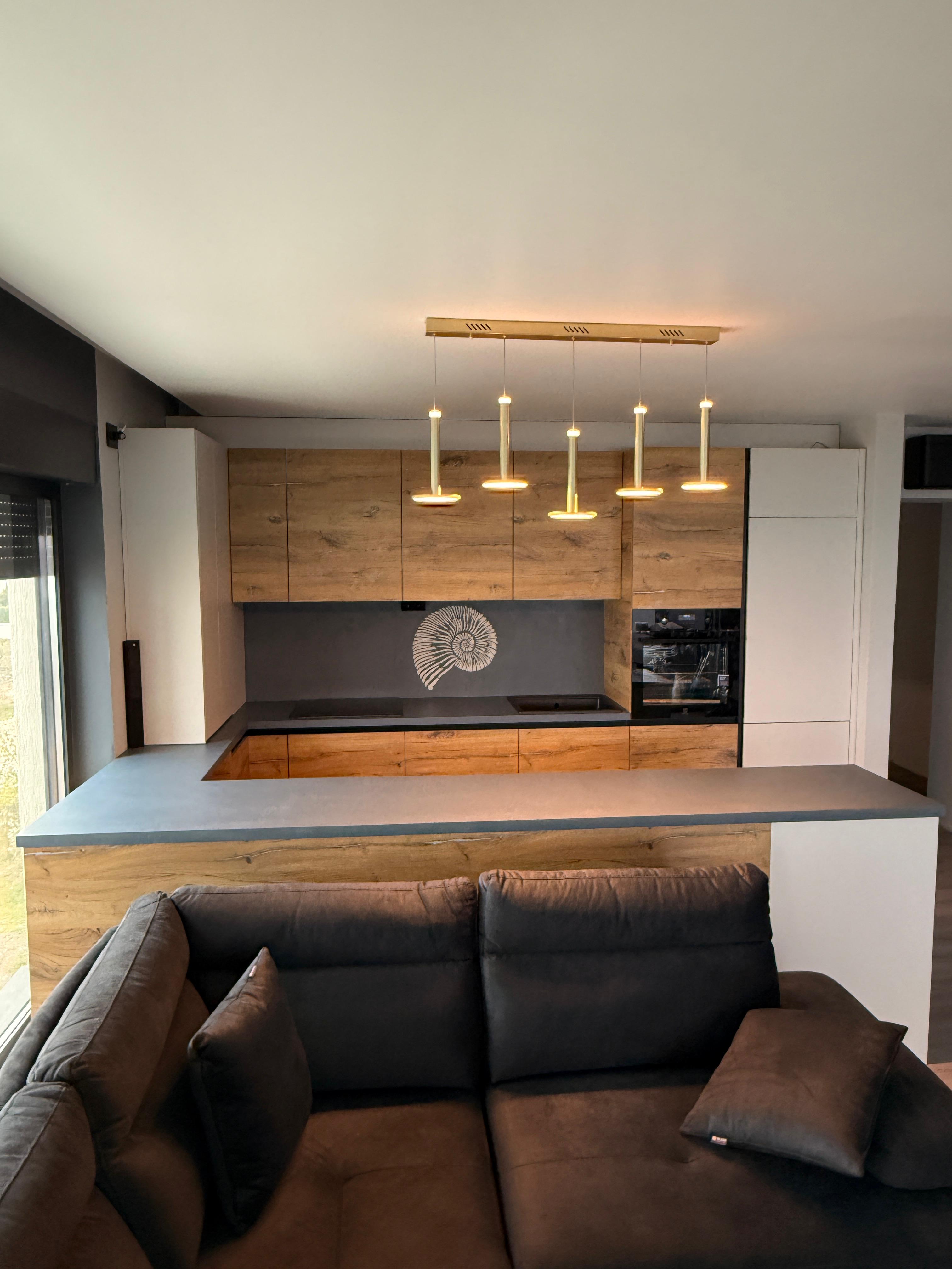 Microcement feature wall with hand-crafted ammonite fossil spiral motif